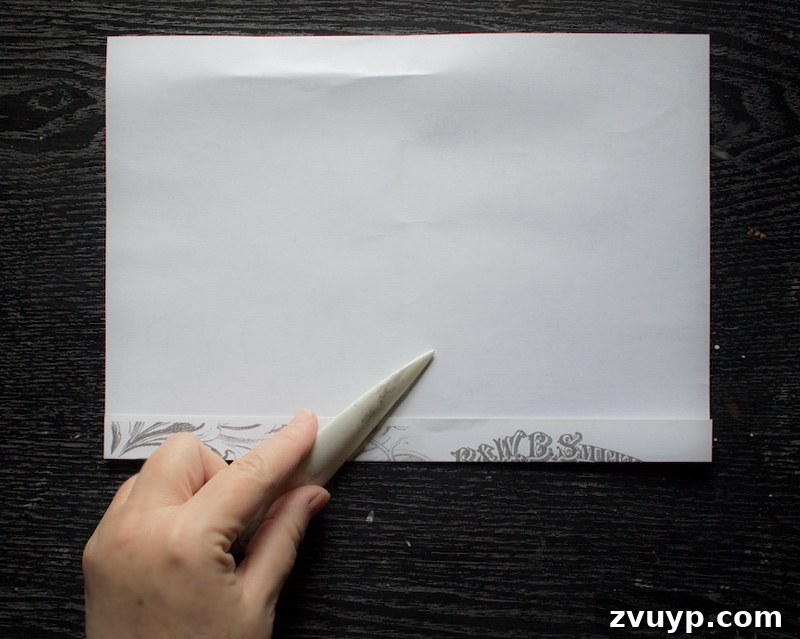 Folding paper - Reinforcing the long edge crease with a bone folder