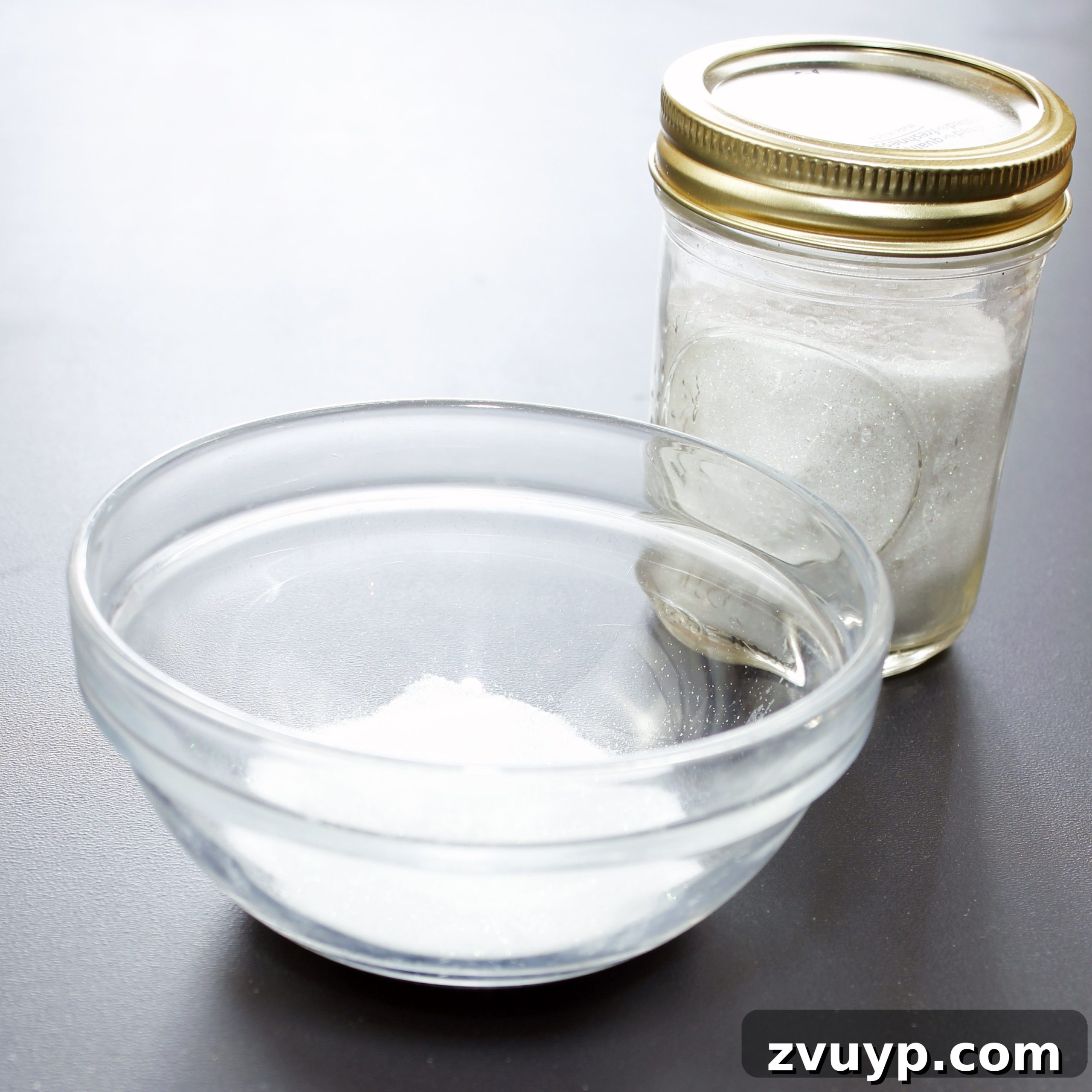 White glitter ready for coloring in a clear plastic container.