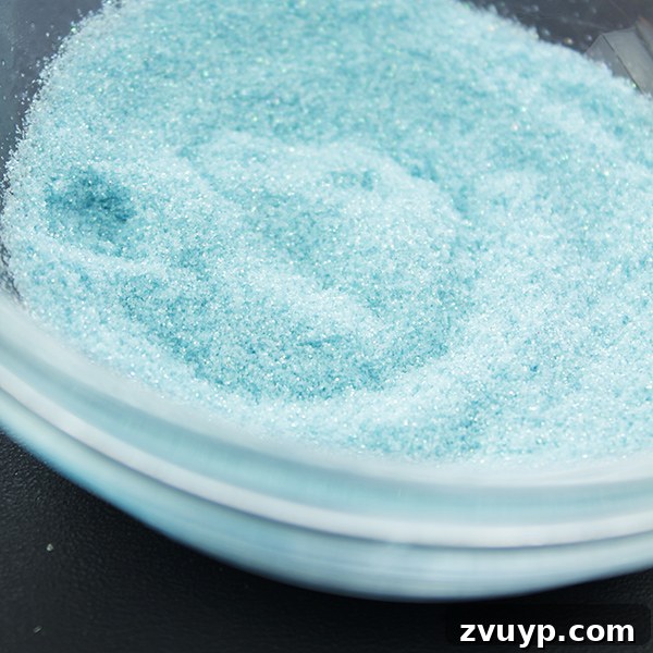 Thoroughly mixing alcohol ink into glitter to create a custom color.