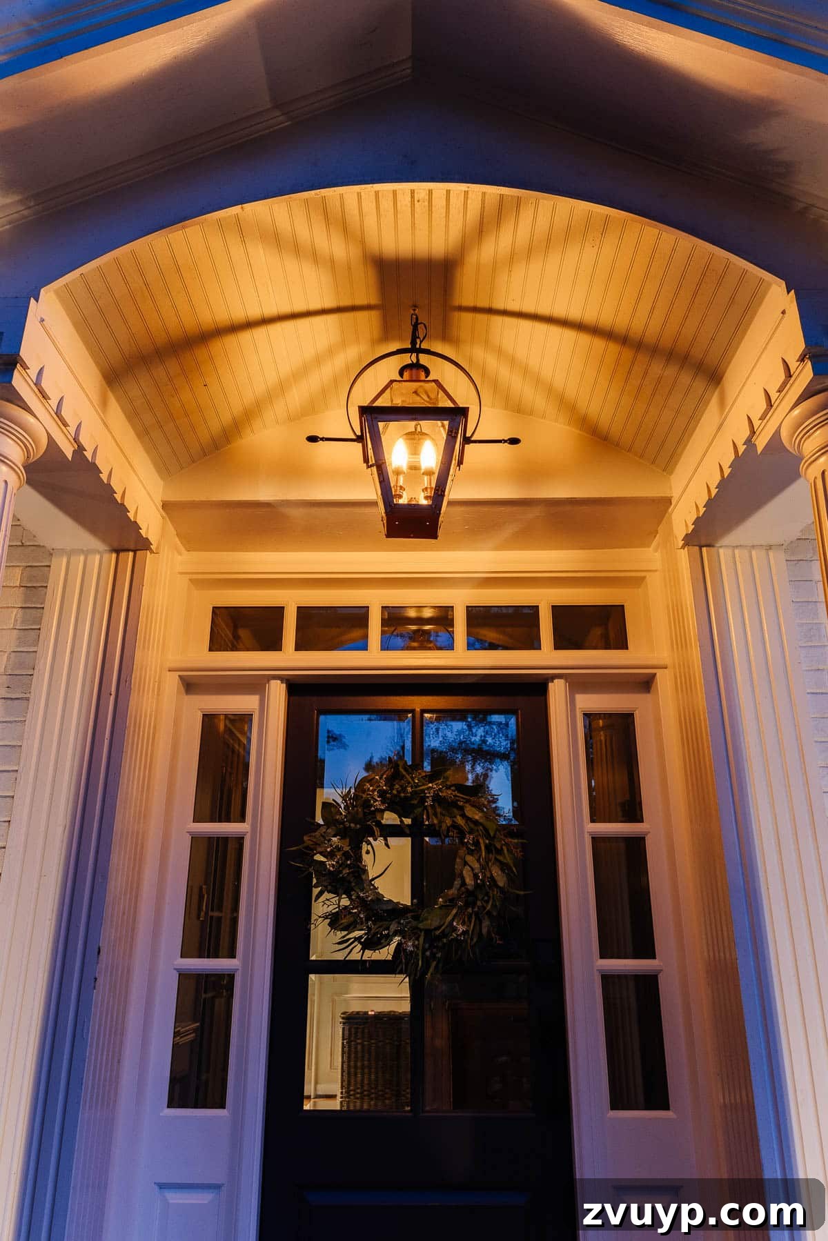 The Ultimate Flame Bulbs for a Vintage Gas Lamp Vibe 8 fake gas lantern on a front porch with flickering flame light bulbs at night