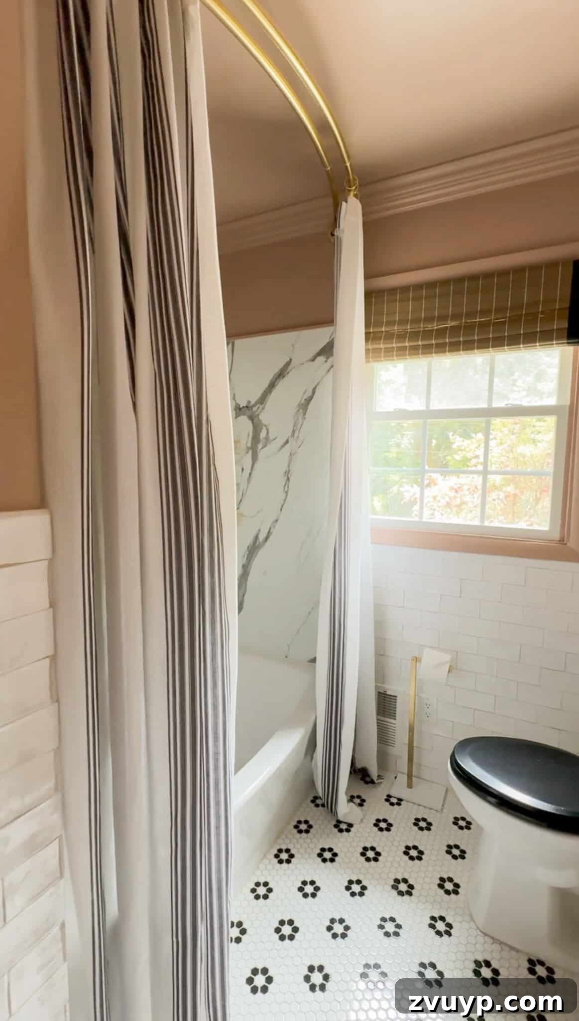 Hang Your Extra Long Shower Curtain Like a Pro 3 A close-up view of double curtain panels used as an extra long shower curtain in a beautifully styled black and pink bathroom.