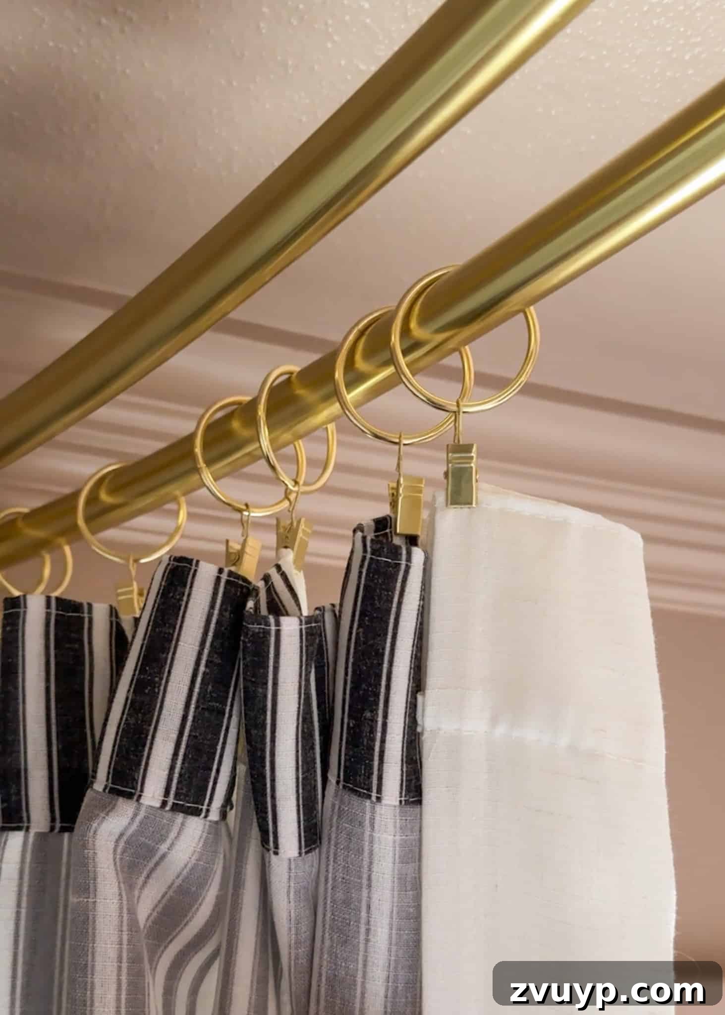Hang Your Extra Long Shower Curtain Like a Pro 8 Close-up of curtain rings clipping decorative window panels to the outer shower rod.