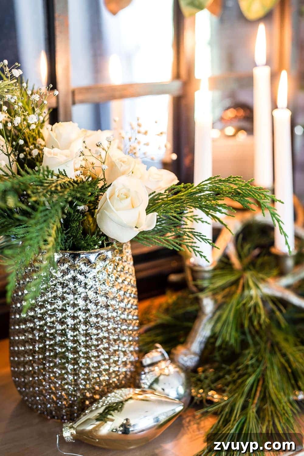 18 Charming Natural Christmas Decorations You Can Make 11 A beautiful Christmas floral arrangement with fresh cedar and elegant white roses, a classic natural decor choice.