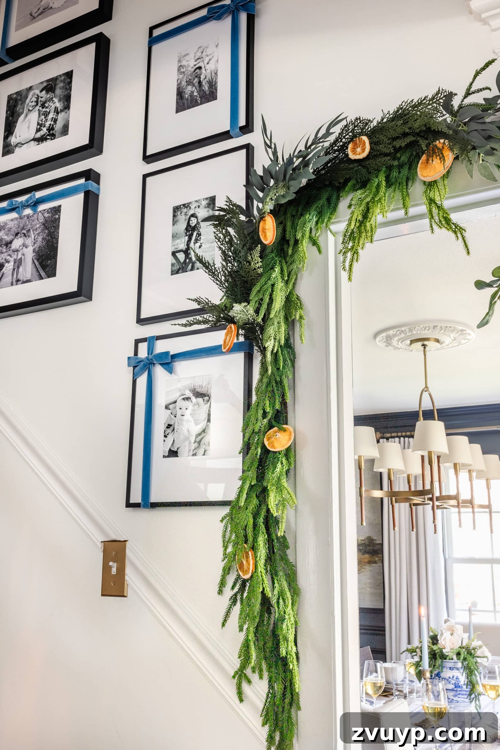 Beyond Believable: Crafting and Perfecting Your Faux Garland 10 garland around a doorway with dried orange slices and blue ribbon