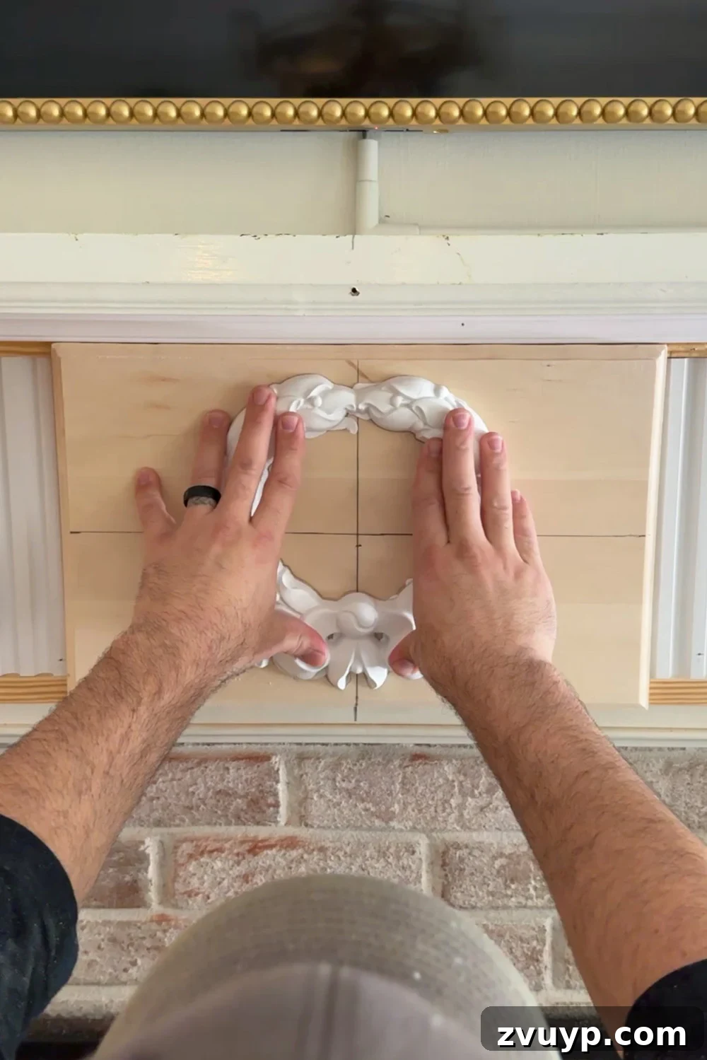 Achieve Timeless Elegance DIY Fireplace Molding Makeover 19 attaching wreath overlay with construction adhesive