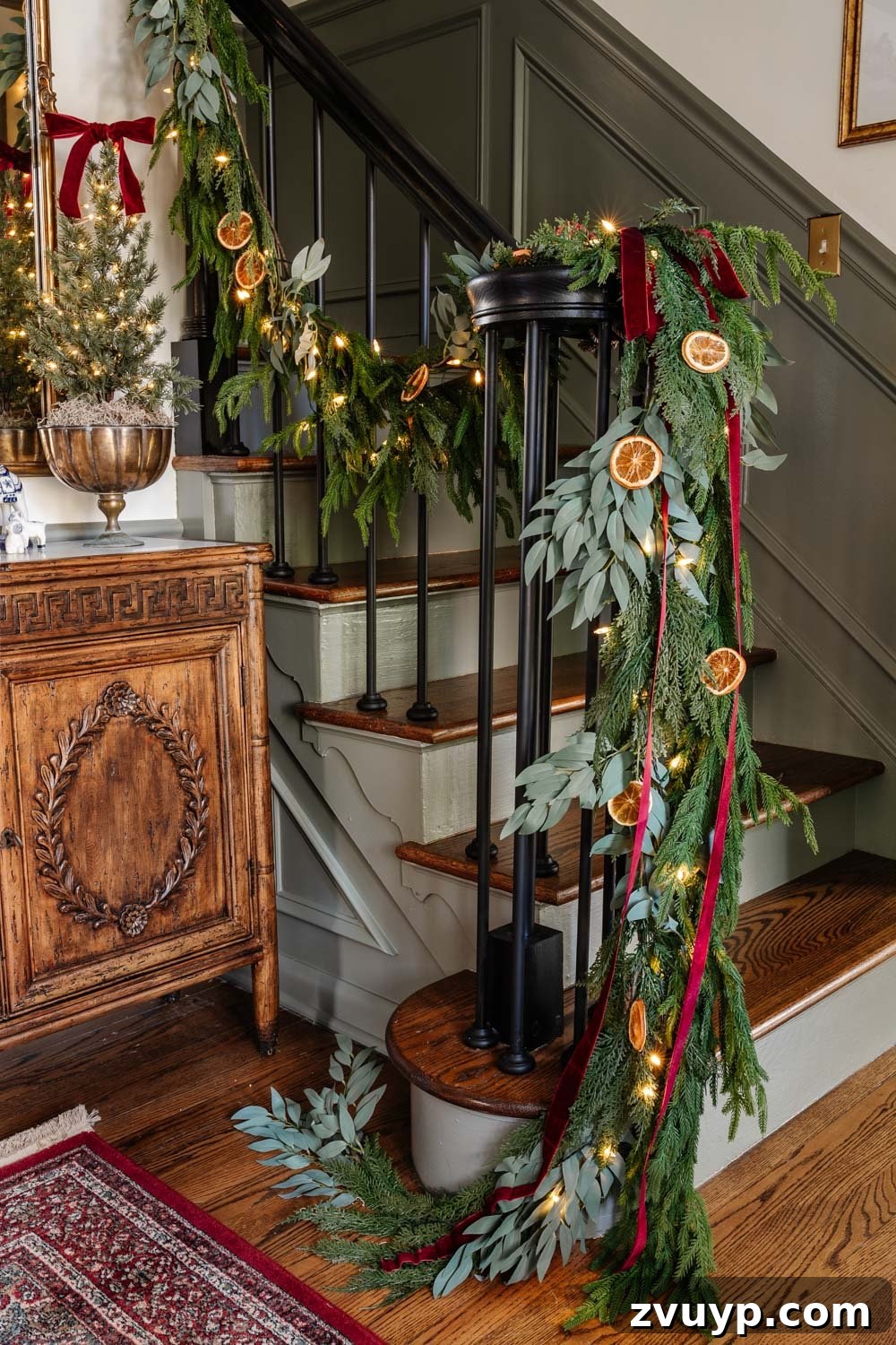 Old-World Christmas Entryway Charm 6 staircase railing garland with dried orange slices and red ribbon