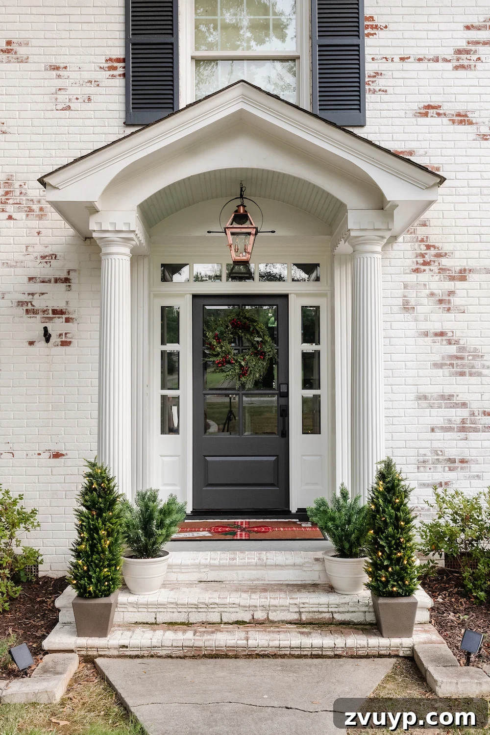 A Modern Colonial Christmas: 2024 Home Inspiration 2 Festive Colonial Porch with Christmas Wreath and Garland