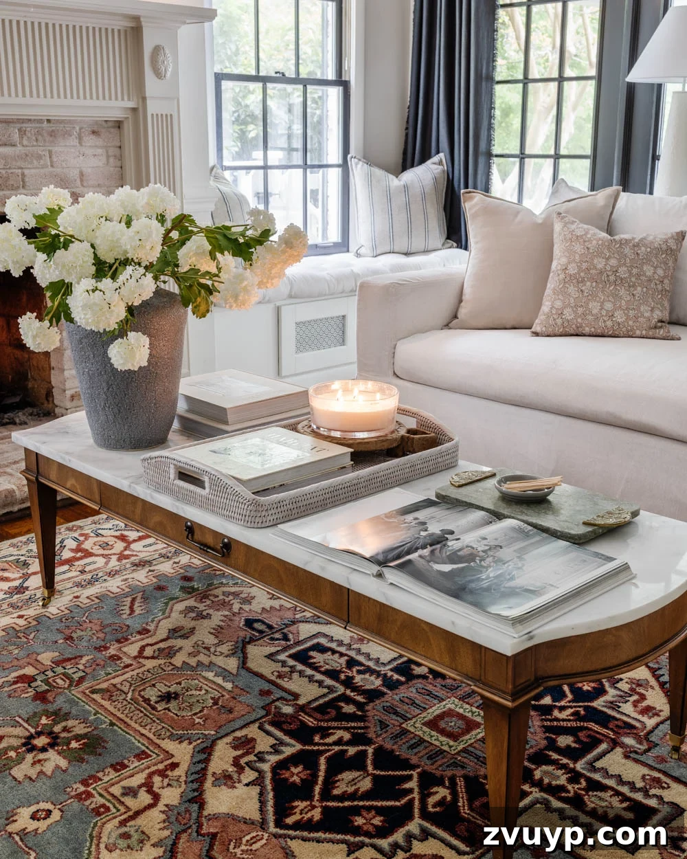 25 Enduring Furniture Designs That Transcend Fleeting Fads 4 Elegant living room featuring a timeless marble coffee table paired with a classic Pottery Barn sofa, embodying enduring style and quality.