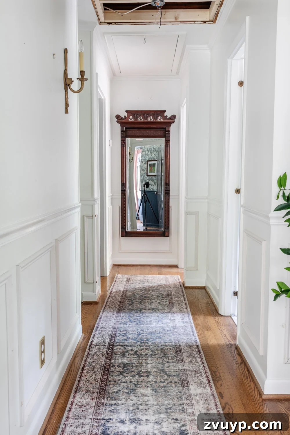 From Concept to Hallway Reality 2 Freshly painted hallway after attic fan removal, showing a blend of modern and vintage styles.