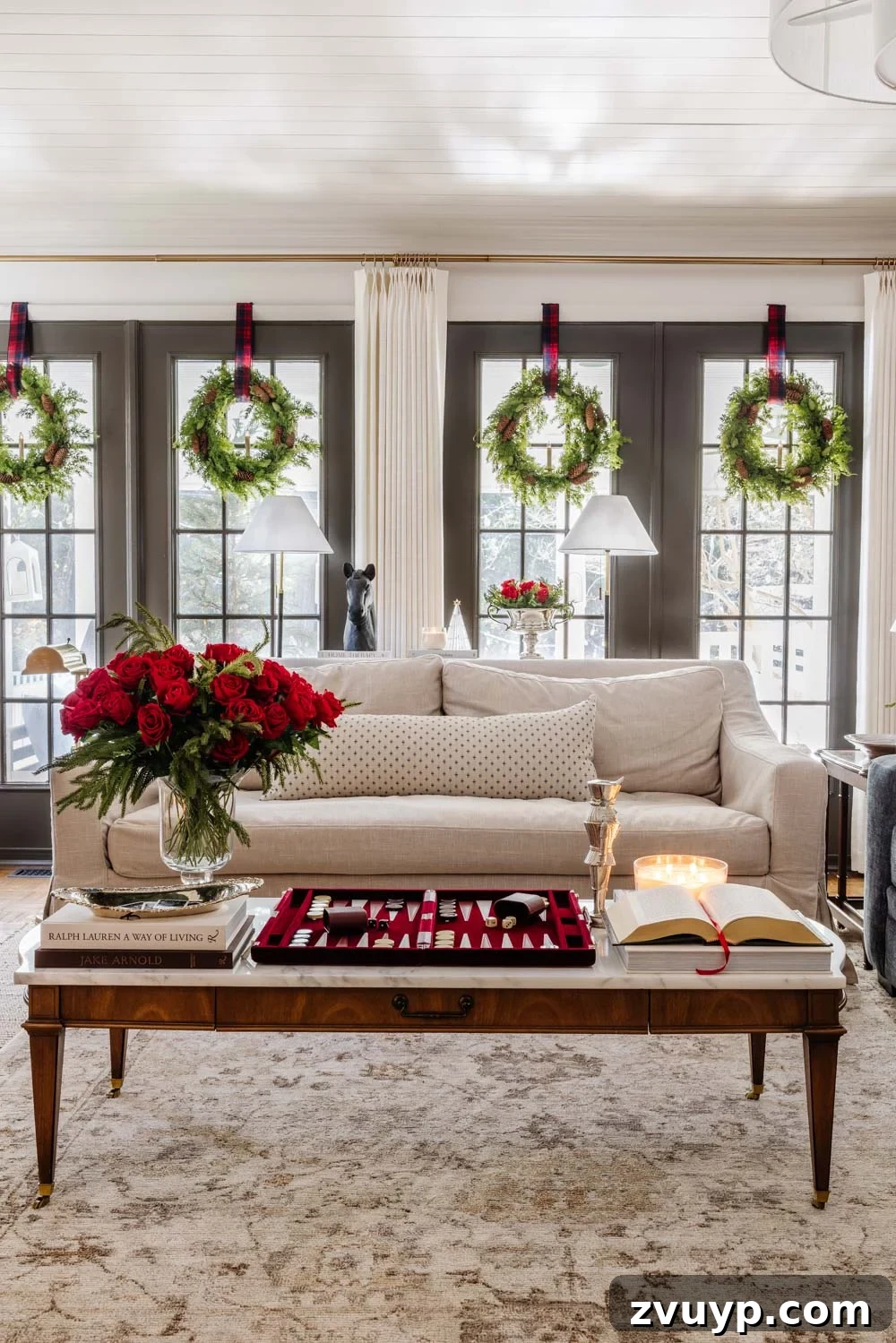 Achieving Ralph Lauren Christmas Elegance on a Dime 12 Ralph Lauren Christmas decorating ideas on a budget - living room interior with a large, decorated Christmas tree and full garland