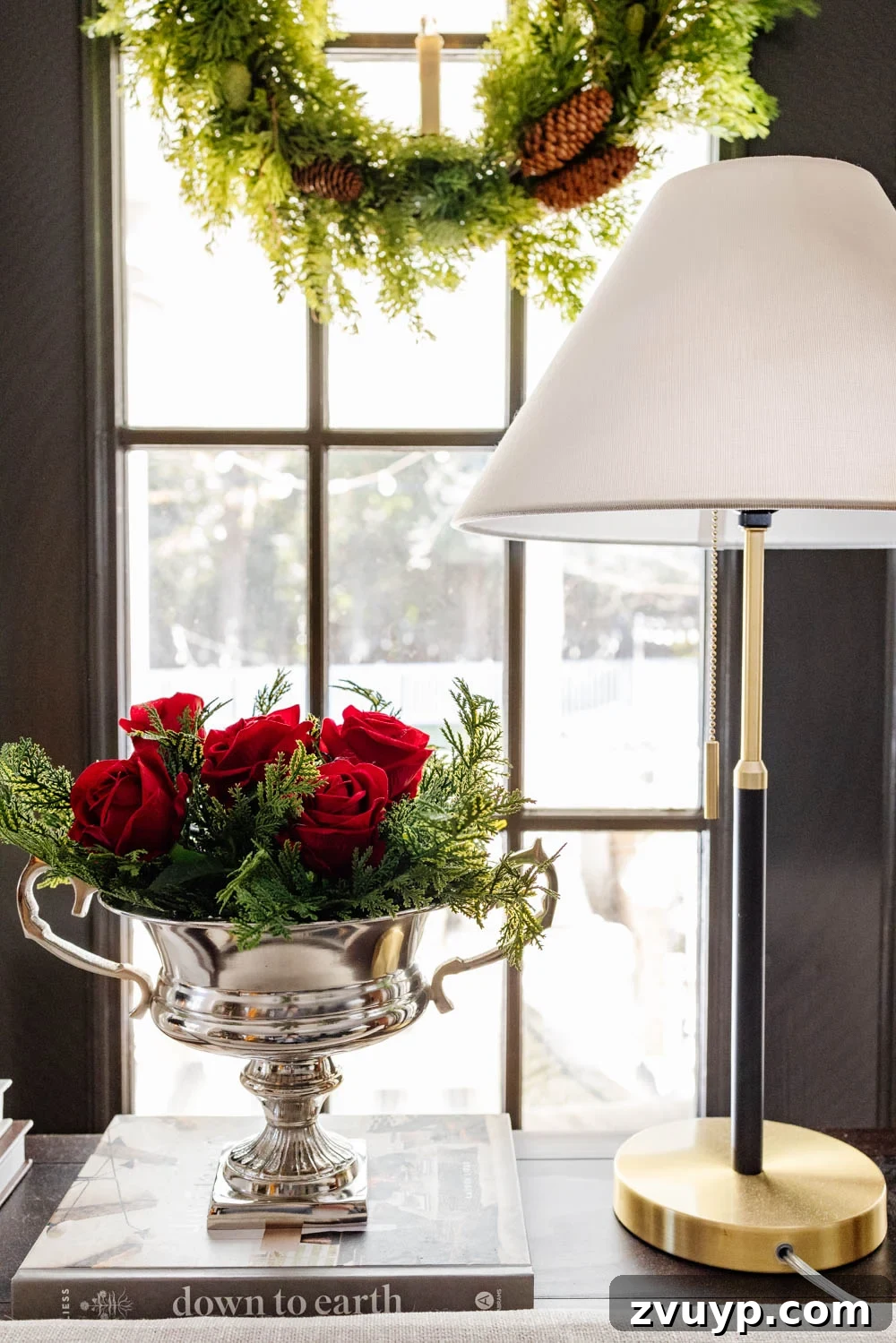 Achieving Ralph Lauren Christmas Elegance on a Dime 4 Ralph Lauren Christmas decorating ideas on a budget - silver urn holding red roses and pine stems, reflecting ambient light