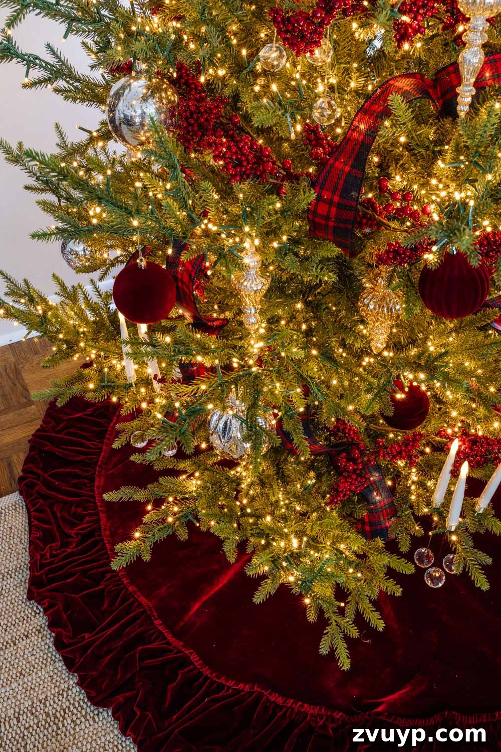 Achieving Ralph Lauren Christmas Elegance on a Dime 9 Ralph Lauren Christmas tree decorating ideas on a budget - red velvet tree skirt and red berry garland with mercury glass ornaments, showcasing traditional elegance