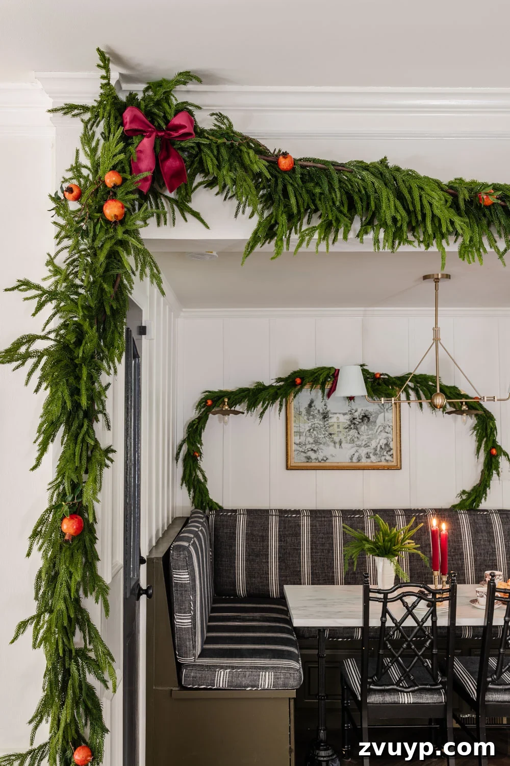 Hang Garland Over Any Doorway Damage-Free and Custom 18 Realistic faux cedar garland around doorway with warm string lights for Christmas.