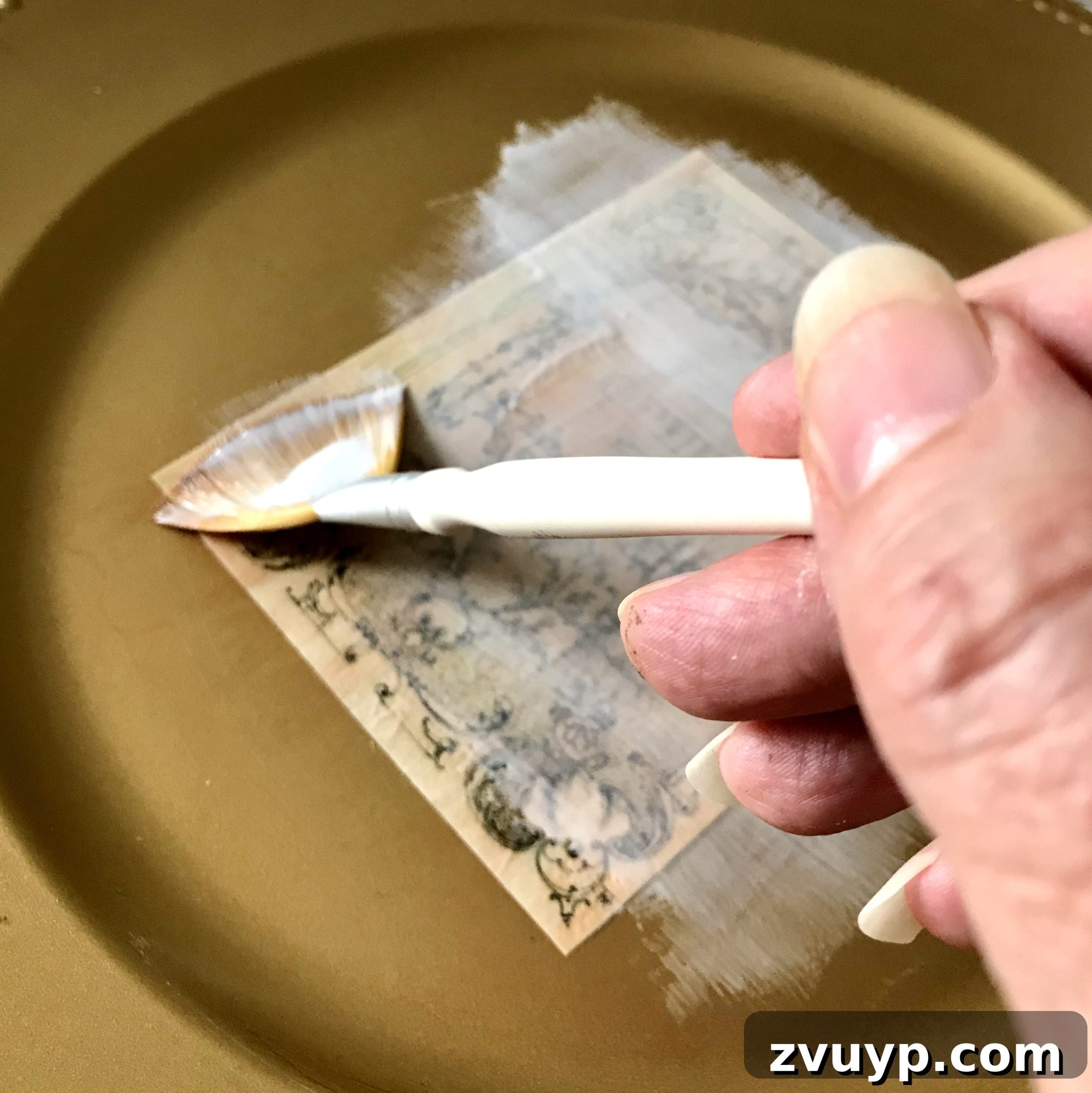 The Ultimate Guide to Decoupage Glue 14 Applying decoupage medium with a brush in an even layer