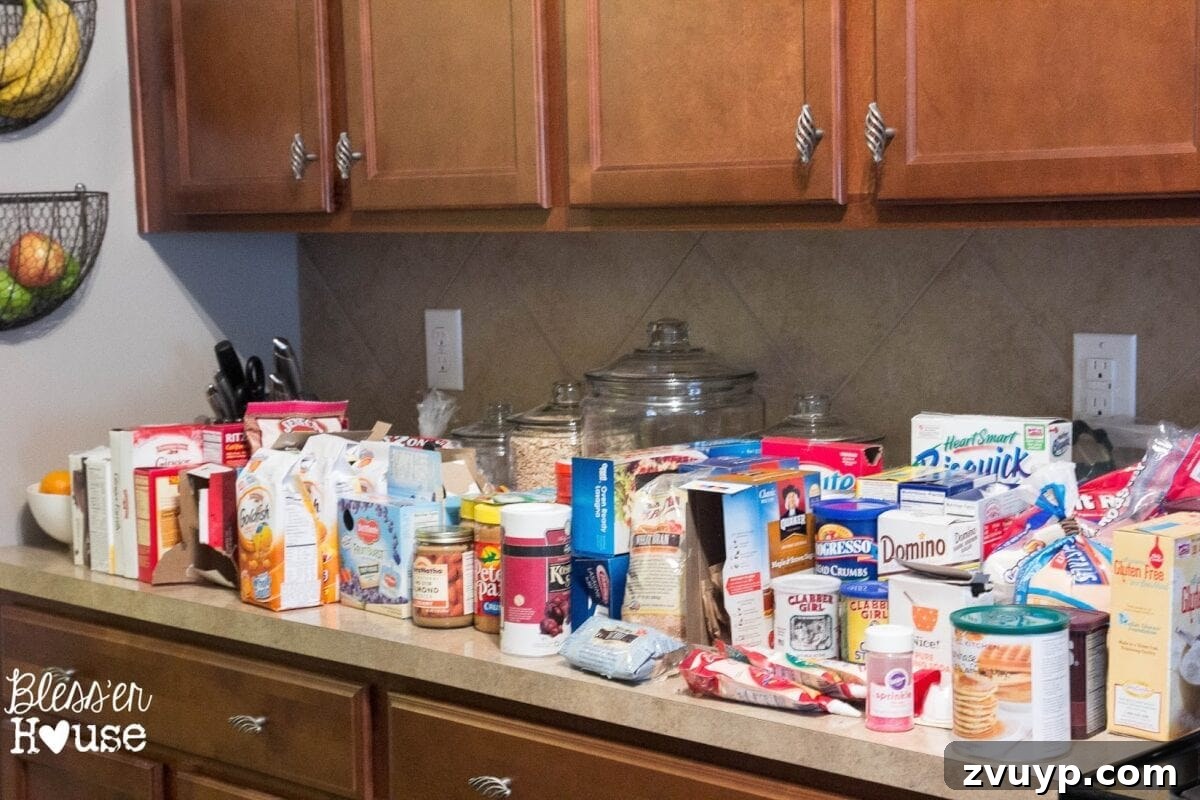 Pantry items spread across kitchen counter during organization