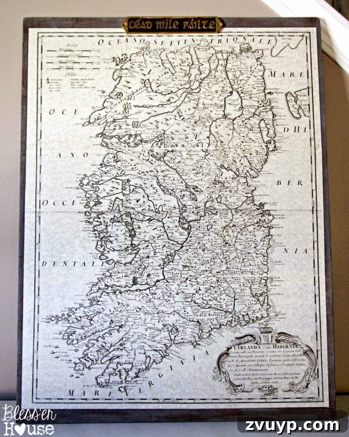Close-up of applying Mod Podge and smoothing a map page onto plywood.