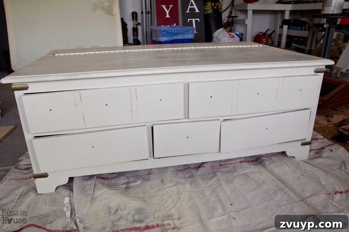 Before: A beige trunk coffee table, showing its original condition before the DIY faux card catalog makeover.