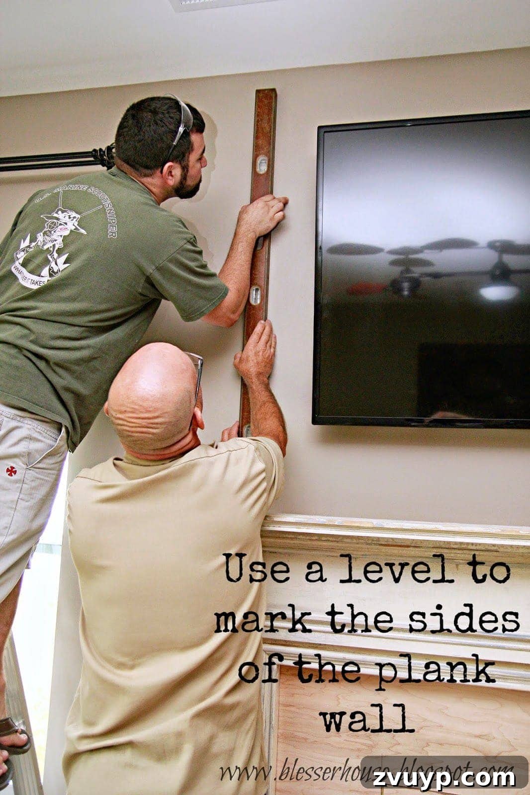 Marking the width of the plank wall with a pencil and level