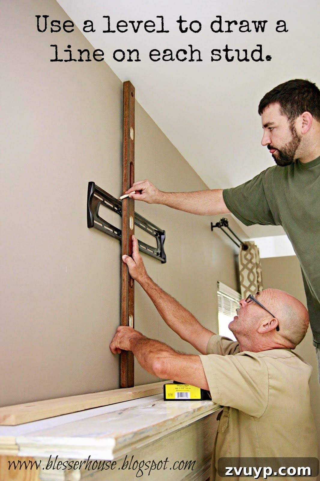 Marking stud locations on the wall with a level