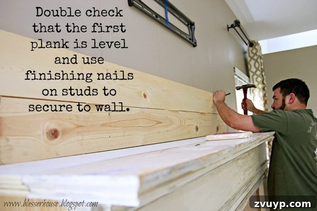 Installing the first pine planks on the wall