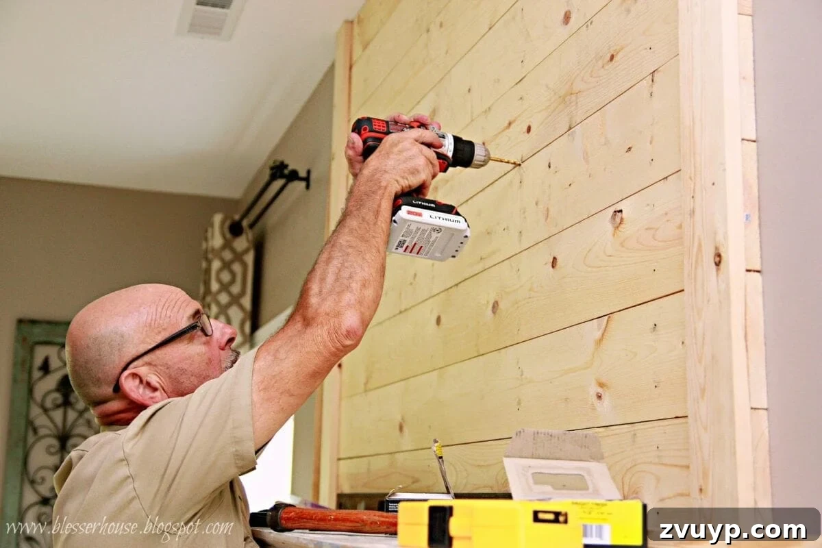 Drilling holes for the TV mount on the plank wall