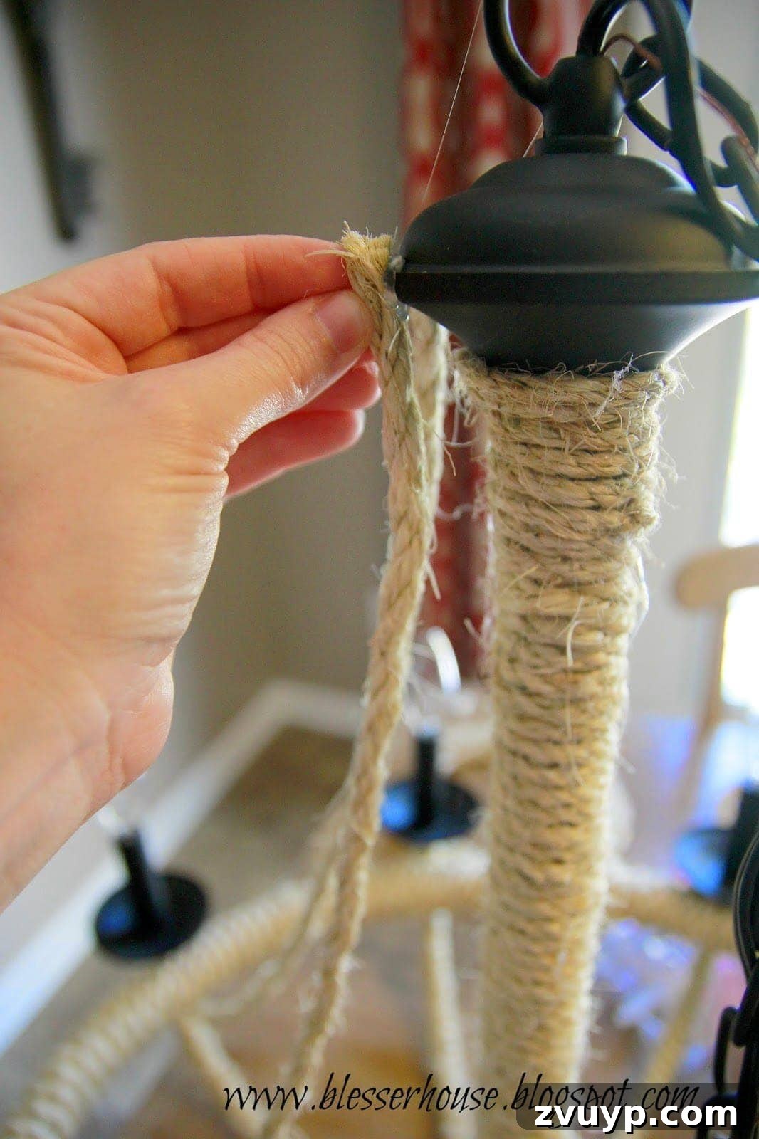 Attaching the top end of a rope swag to the chandelier