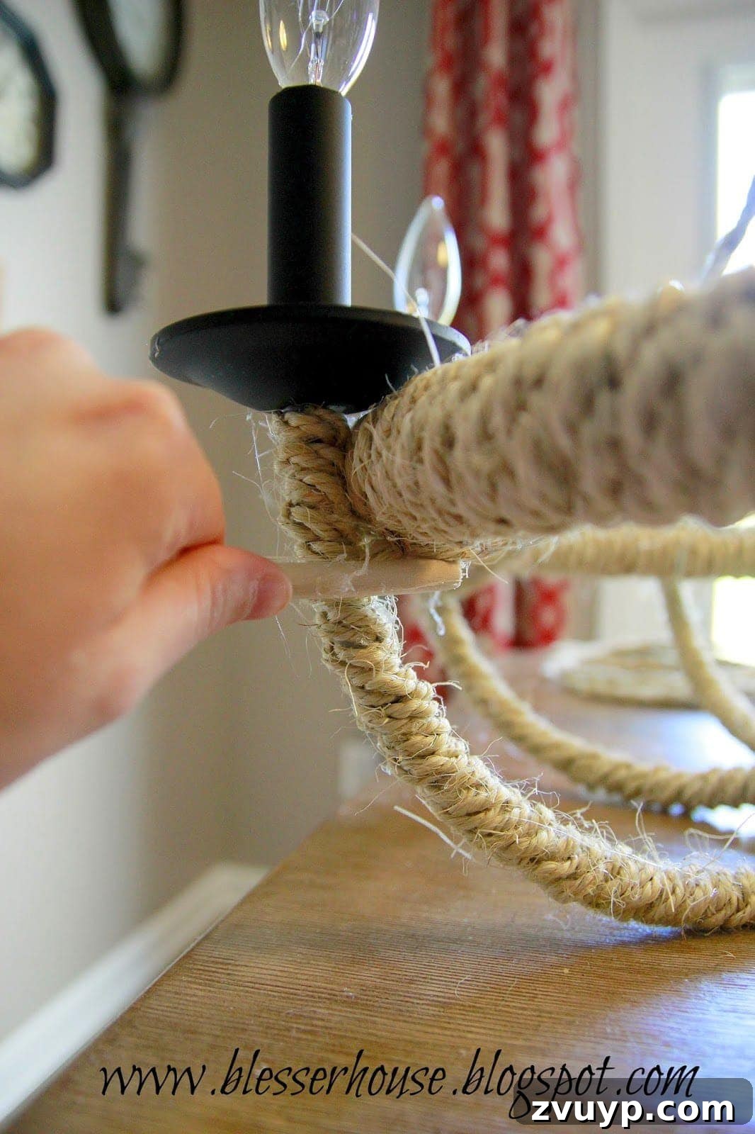Securing rope swags to the hula hoop below the lights
