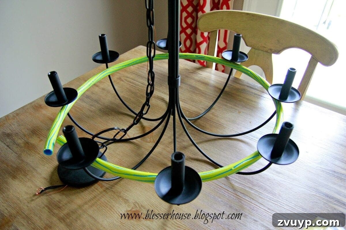 Measuring and cutting the hula hoop to fit the chandelier