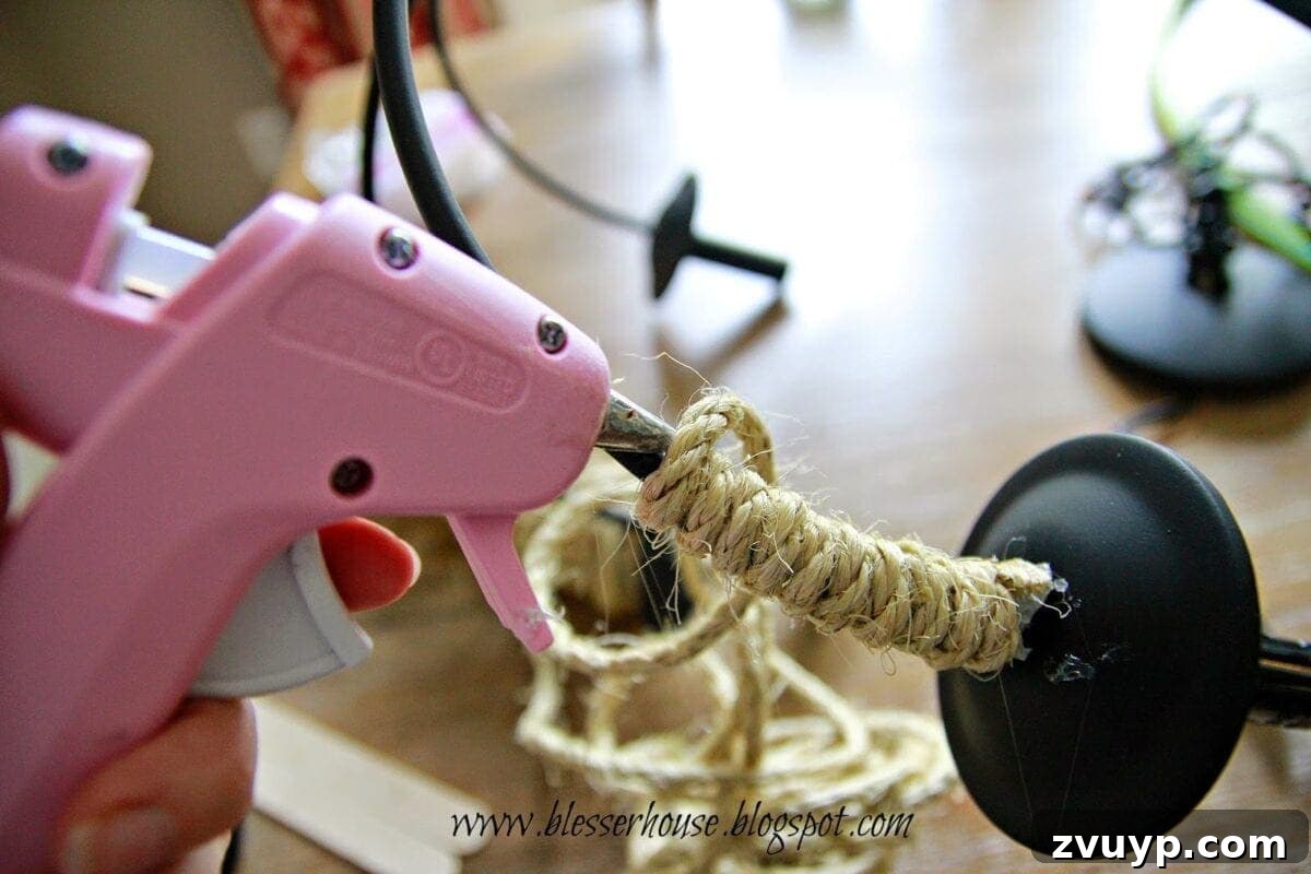 Wrapping chandelier arms with 1/4 inch sisal rope and hot glue