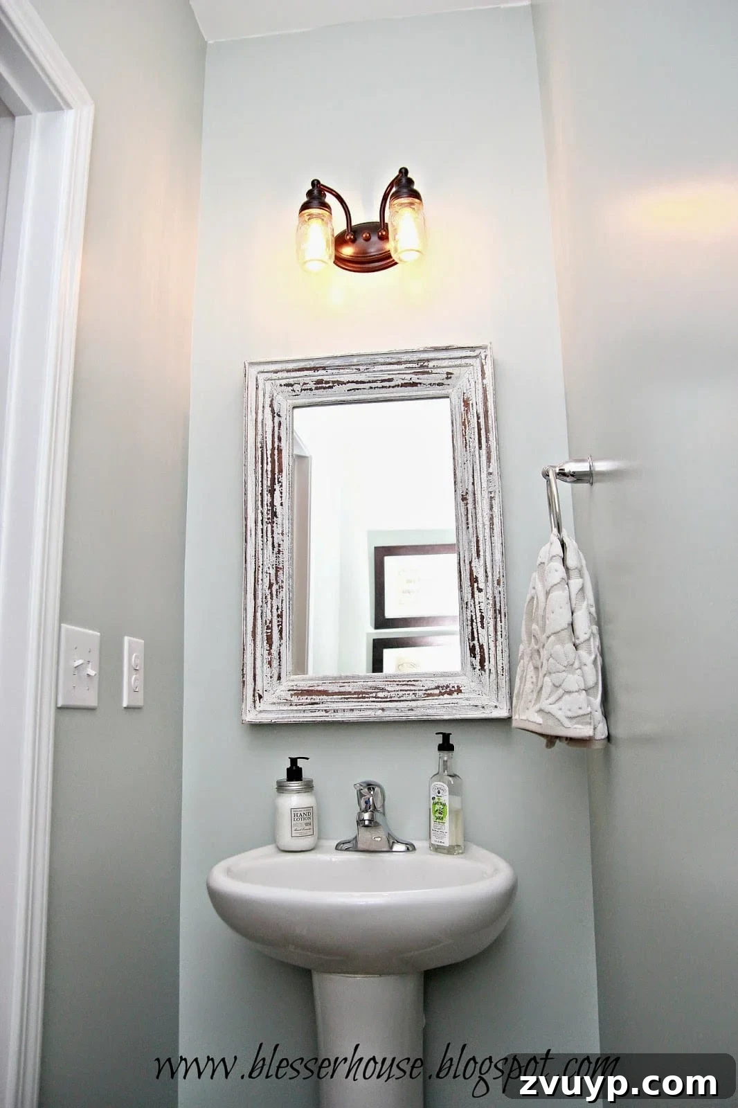 Overview of a farmhouse-style powder room with the new mason jar vanity light and coordinating decor