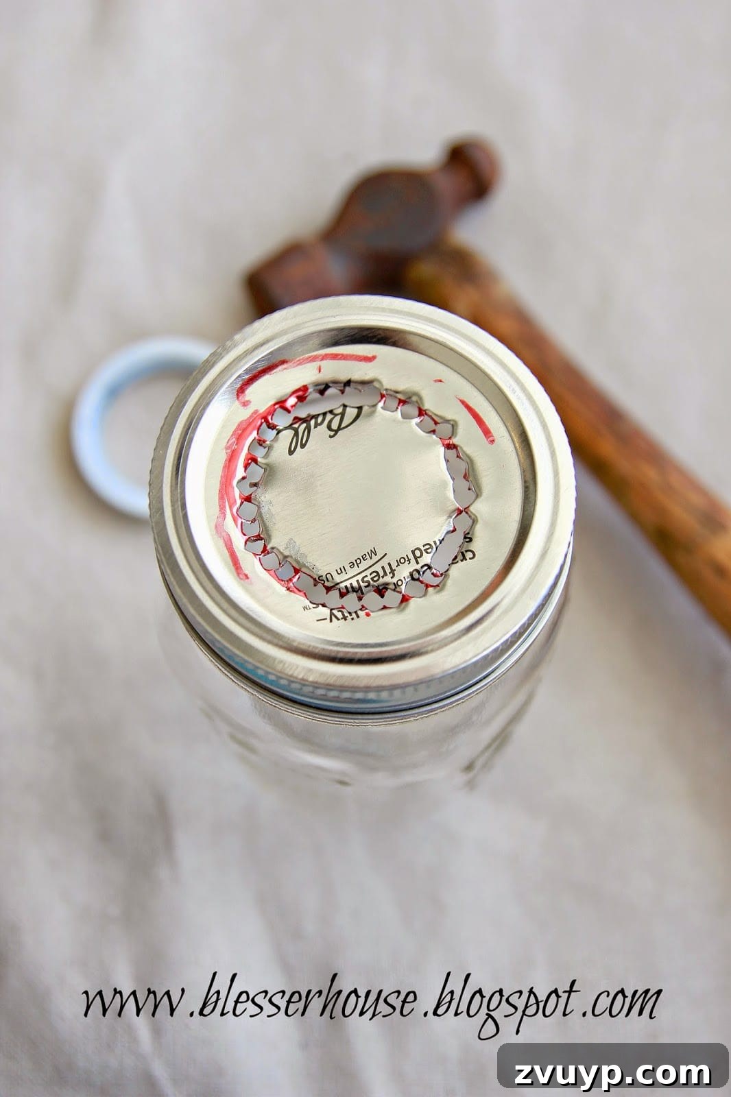 Mason jar lid with the center punched out, ready for assembly