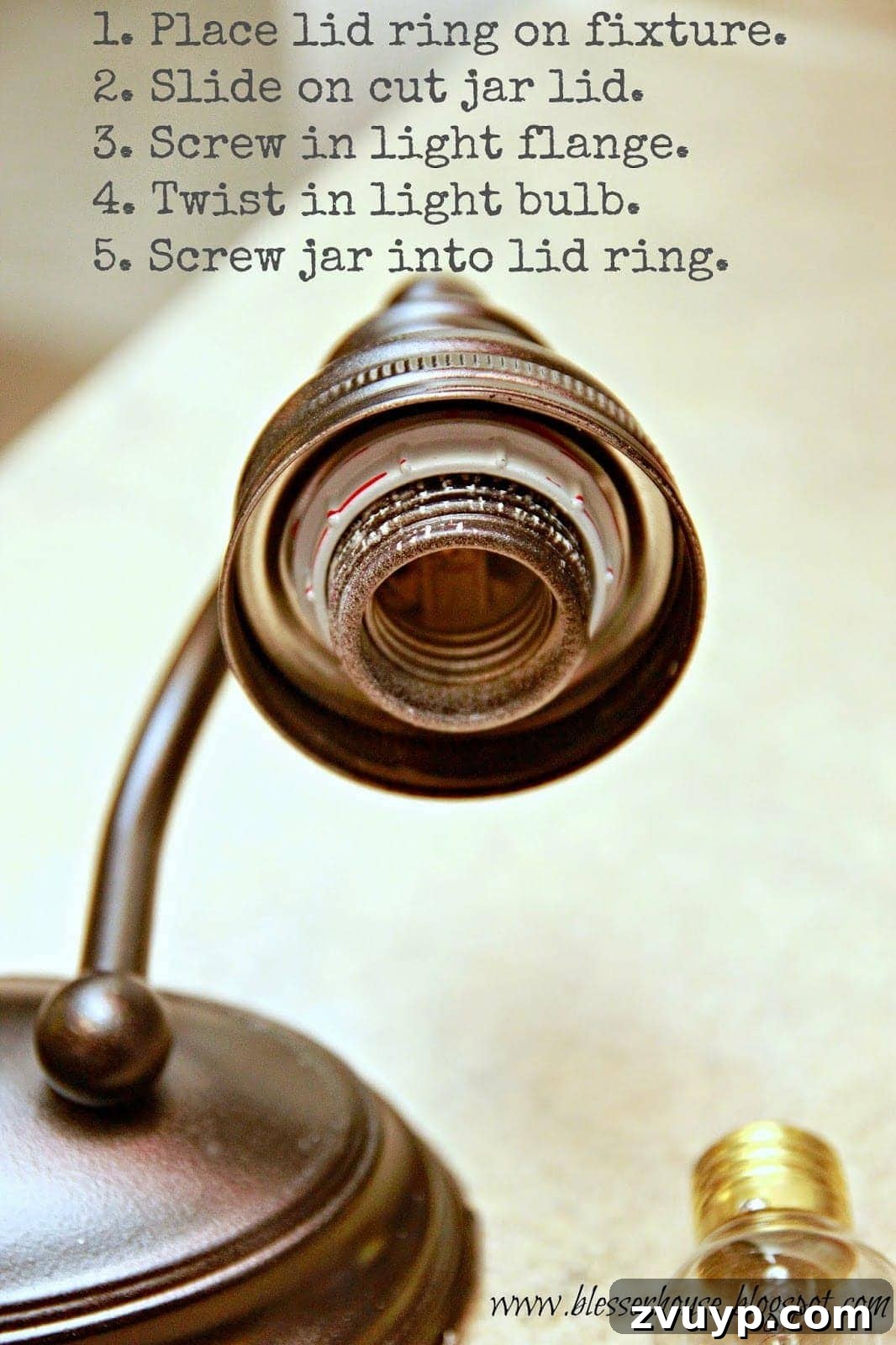 Demonstration of assembling the mason jar shade onto the light fixture socket