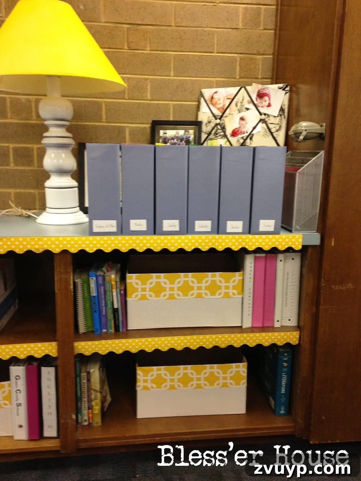 Neatly organized paper ream boxes, repurposed and decorated, used for storing copies and lesson plan materials.