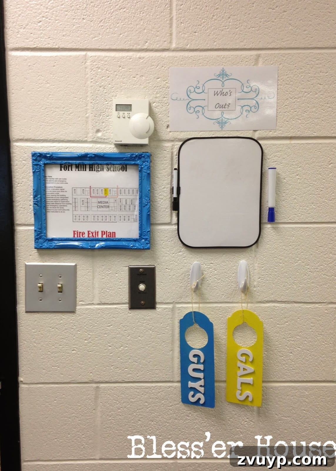 An organized exit station by the classroom door, including a bathroom pass and a sign-out board for students.