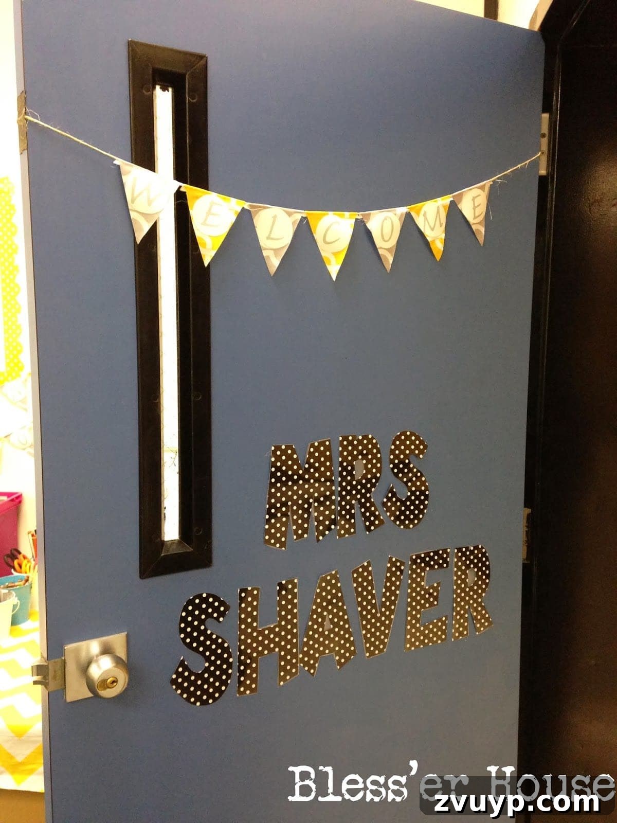 A brightly decorated classroom door with a 'Welcome' sign, adorned with colorful bunting, inviting students inside.