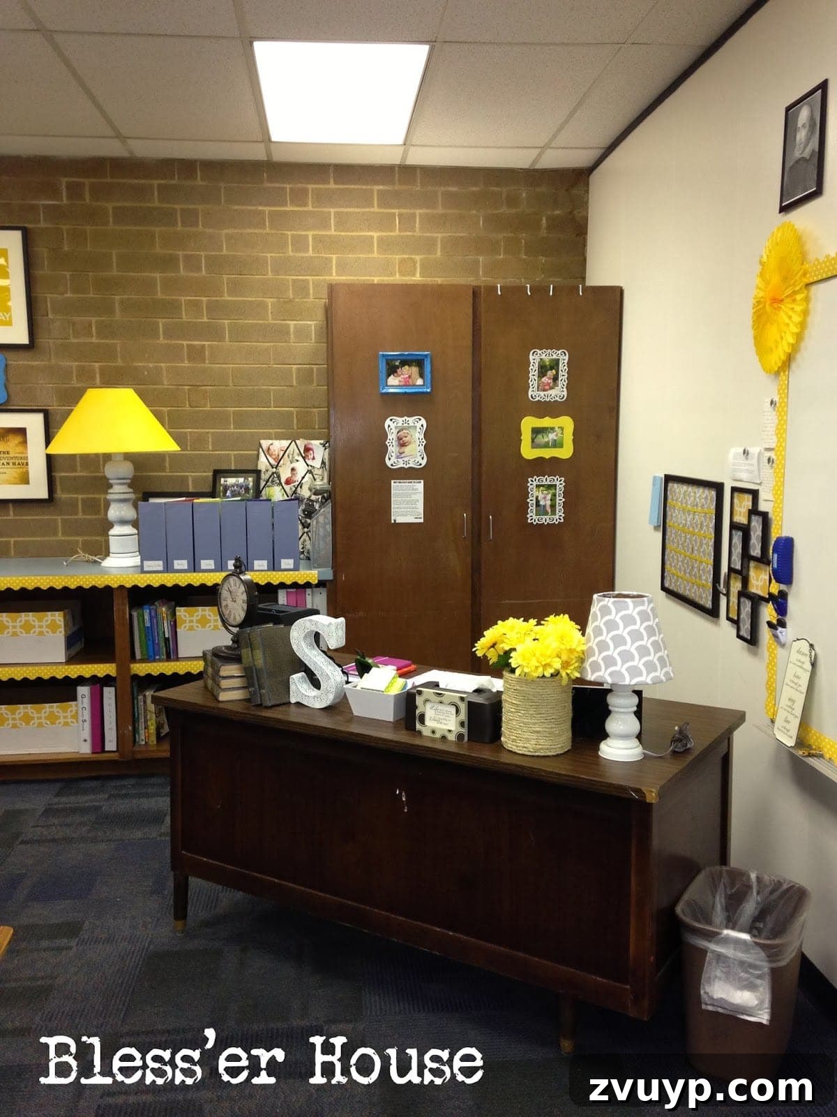 The teacher's desk area, styled with personal decor items like a rope-wrapped coffee can, framed art, and antique books.