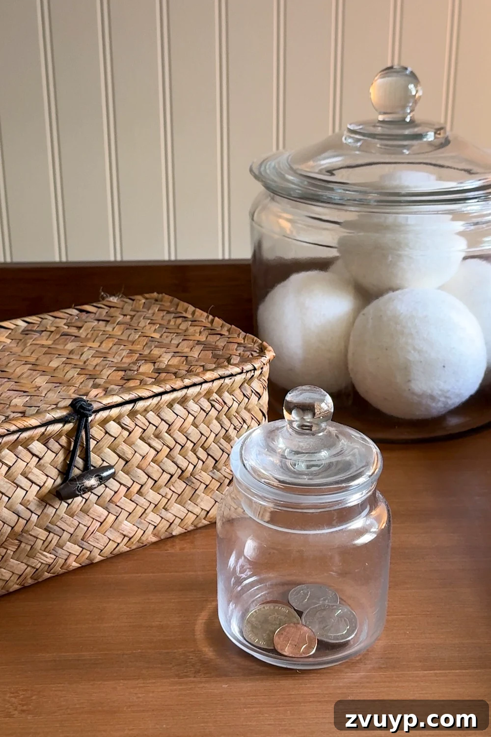 Unlock Hidden Storage in Your Small Laundry Room 23 small laundry room organization - basket and apothecary jars for loose change, lost socks, and wool dryer balls