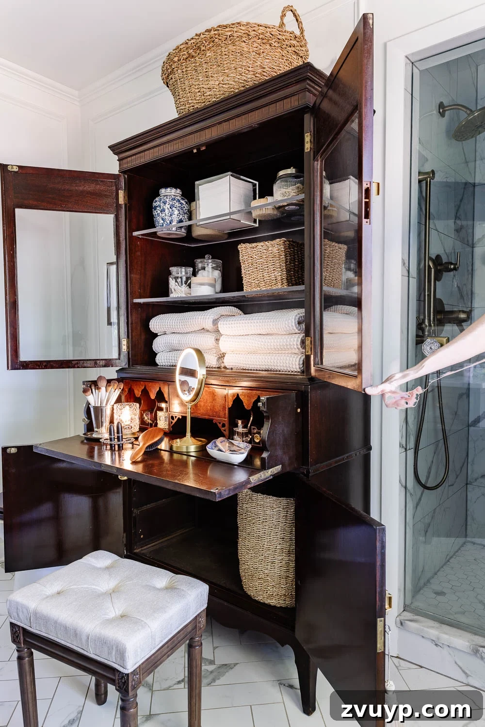 Secretary Desk Transformation: DIY Makeup Vanity for Small Bathrooms 5 Detailed shot of the secretary desk's top cabinet and drop-down desk surface open, revealing organized makeup and bathroom essentials.