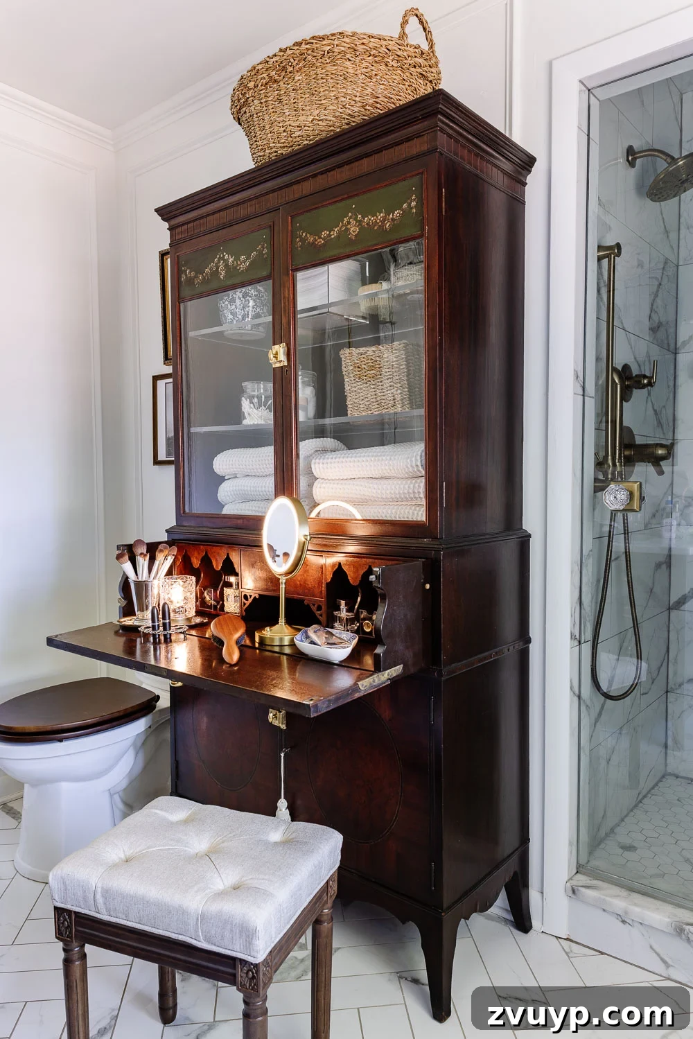 Secretary Desk Transformation: DIY Makeup Vanity for Small Bathrooms 10 Secretary desk bottom cabinet open, revealing a makeup stool and a woven hamper basket neatly stored inside.