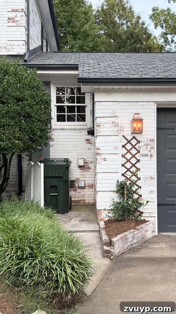 garage curb appeal with copper lanterns, star jasmine, and outdoor trash can hiding panels