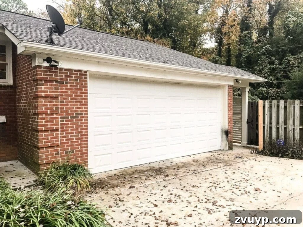 garage curb appeal with copper lanterns, star jasmine, and outdoor trash can hiding panels