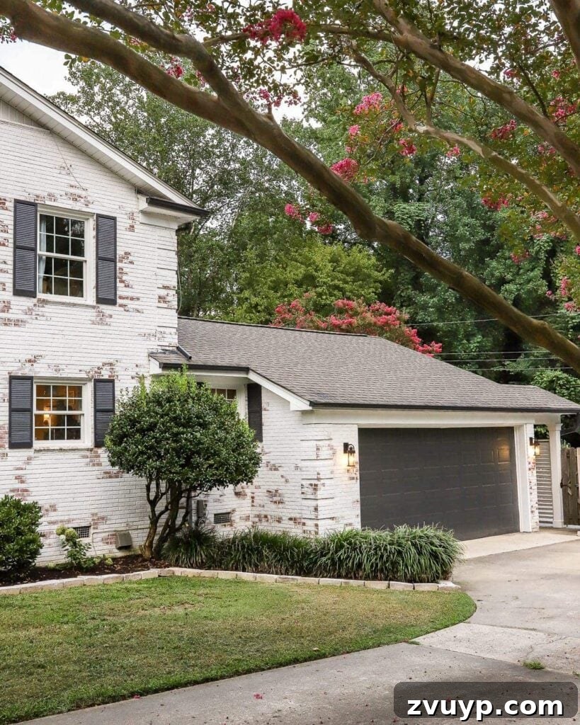 garage curb appeal with copper lanterns, star jasmine, and outdoor trash can hiding panels