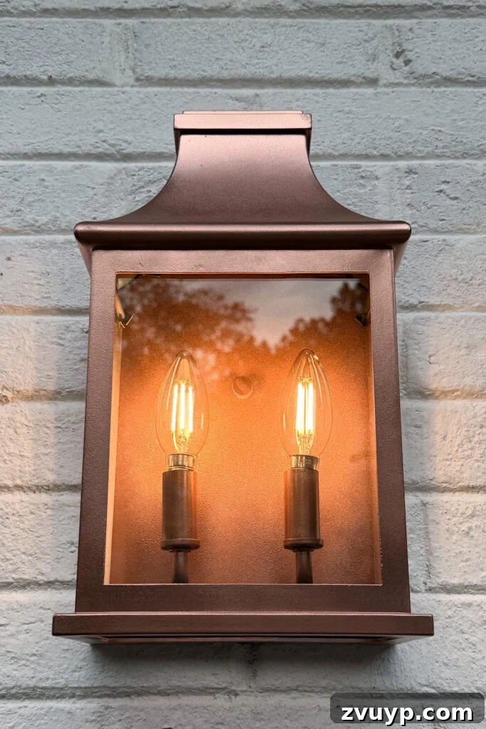 garage curb appeal with copper lanterns, star jasmine, and outdoor trash can hiding panels